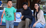 San Mateo County staff distributing backpacks to a client.